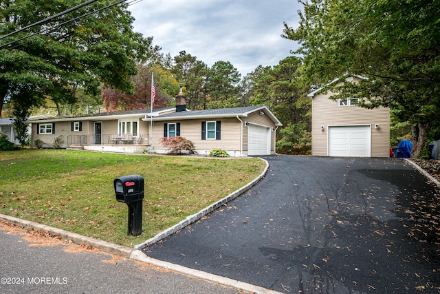 ranch-style house featuring a front yard and a garage