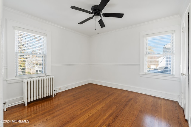 spare room featuring radiator heating unit, hardwood / wood-style flooring, a wealth of natural light, and ceiling fan