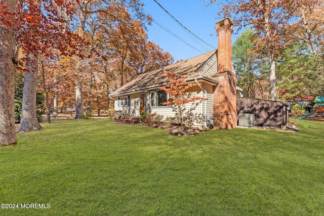 view of side of home with a yard