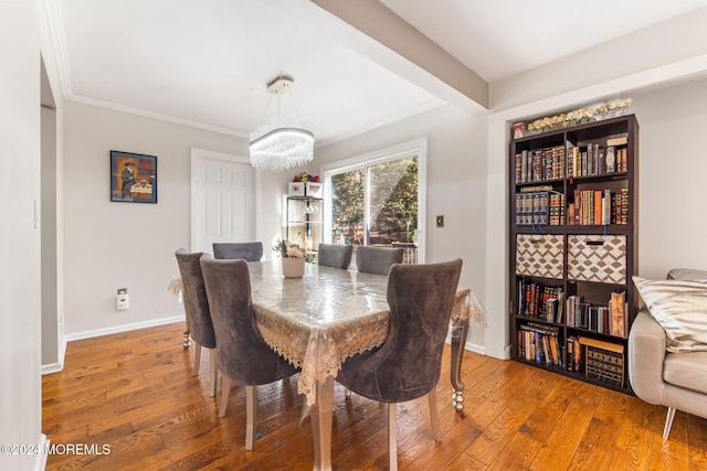 dining room featuring ornamental molding and wood-type flooring