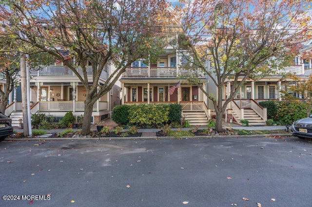 view of front of property with covered porch and a balcony