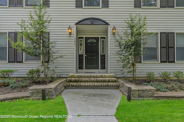 doorway to property featuring a yard