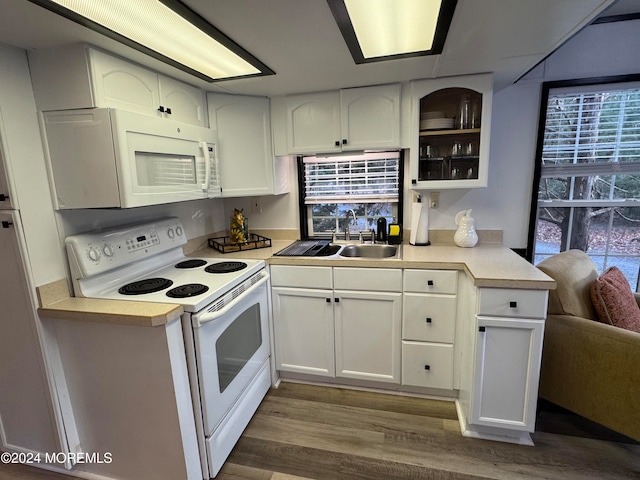 kitchen with white cabinetry, sink, white appliances, and dark hardwood / wood-style floors