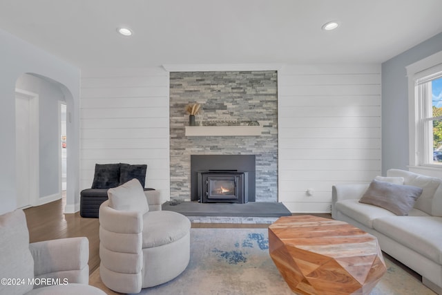 living room featuring wood-type flooring and a large fireplace