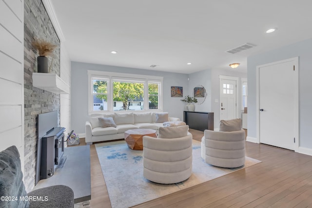 living room featuring a wood stove and hardwood / wood-style floors