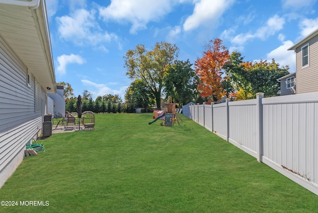 view of yard with a patio and a playground