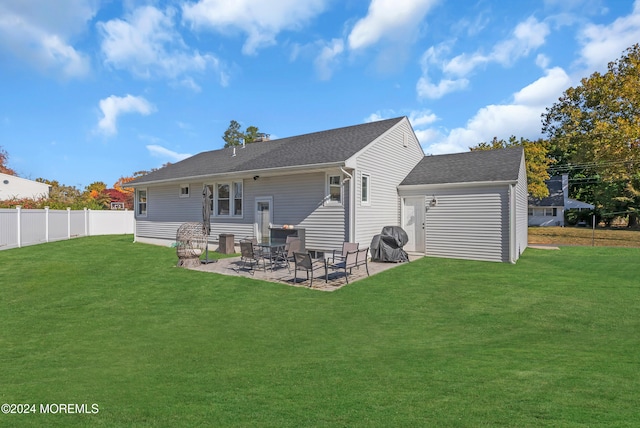 rear view of house featuring a patio and a yard