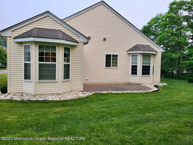 back of house with a yard and a patio area