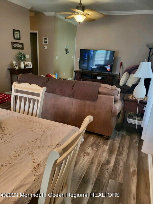 living room with ornamental molding, hardwood / wood-style flooring, and ceiling fan