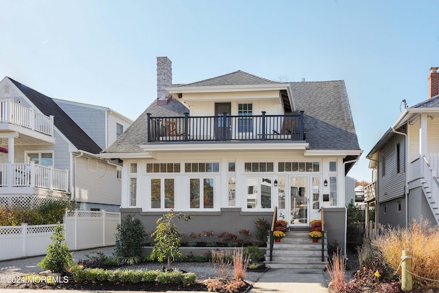 view of front of home featuring a balcony