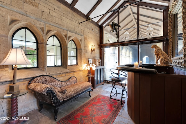 sitting room featuring high vaulted ceiling, a wealth of natural light, and beam ceiling