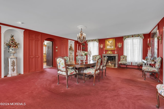 carpeted dining room featuring an inviting chandelier