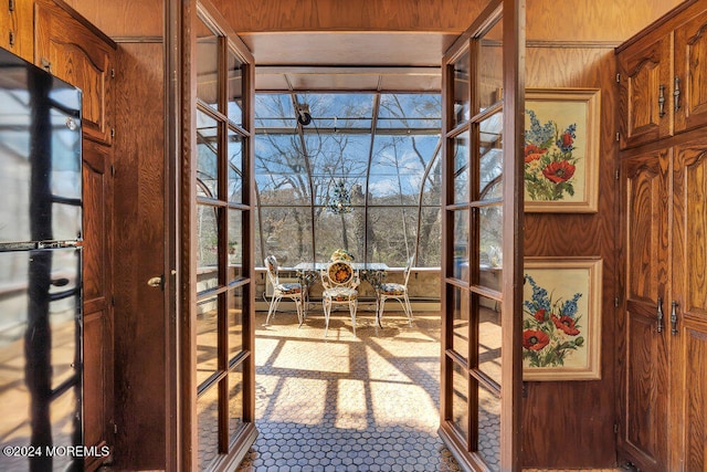 doorway featuring wood walls