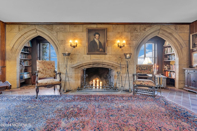 unfurnished living room featuring a tile fireplace