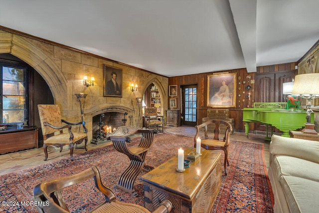 living room with wood walls and beamed ceiling