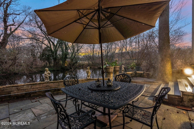 patio terrace at dusk with a water view