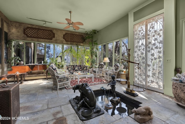 view of patio / terrace with ceiling fan and a baseboard radiator