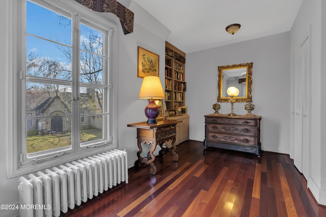 hall featuring radiator heating unit and dark wood-type flooring