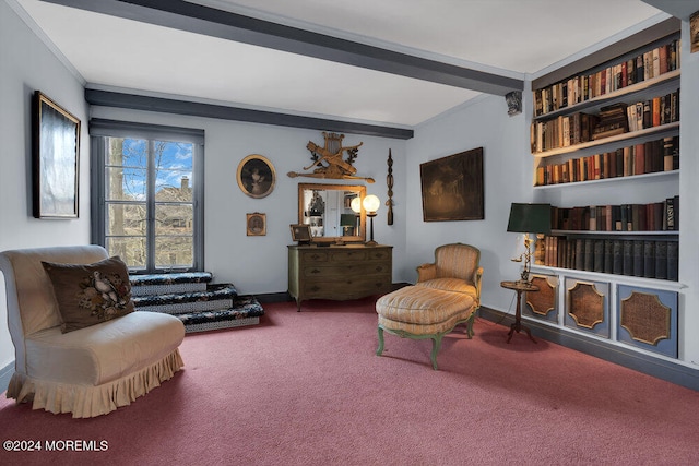 living area featuring carpet flooring, ornamental molding, and beamed ceiling