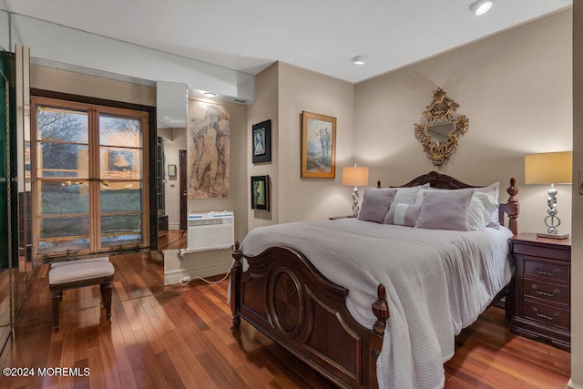 bedroom with wood-type flooring and an AC wall unit