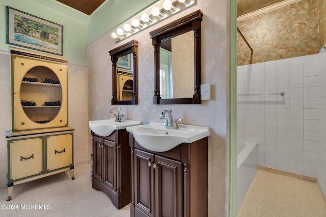 bathroom with ornamental molding, tile patterned flooring, vanity, and a tub