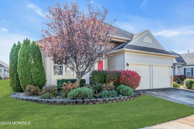 obstructed view of property with a garage and a front yard