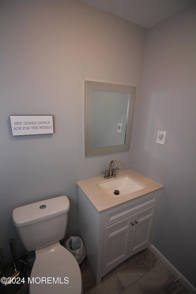 bathroom featuring vanity and toilet