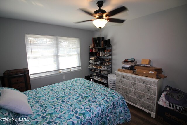 bedroom featuring ceiling fan and dark wood-type flooring