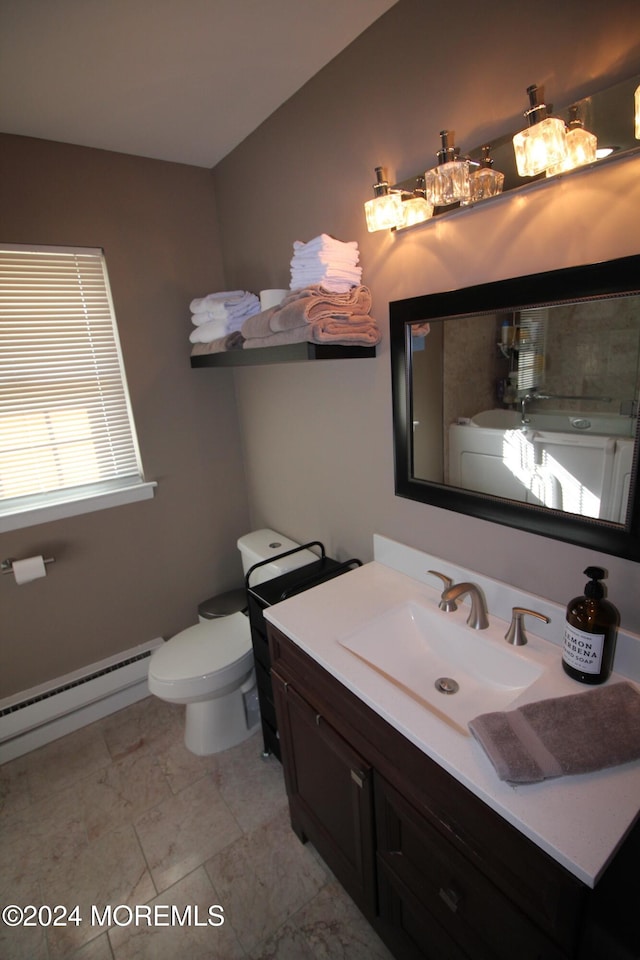 bathroom with baseboard heating, vanity, and toilet