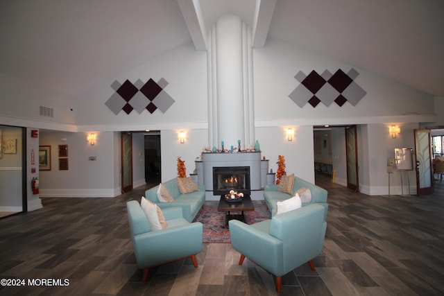 living room featuring dark hardwood / wood-style floors, a fireplace, and high vaulted ceiling