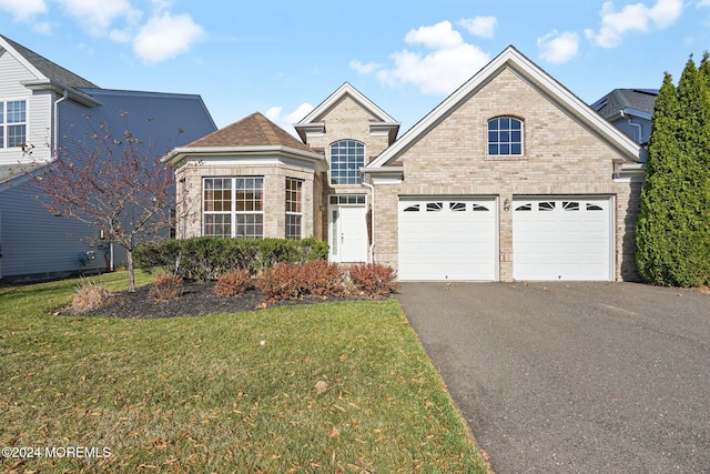 front facade featuring a front yard and a garage