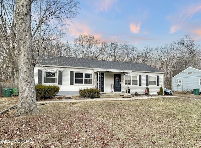 ranch-style home featuring a lawn