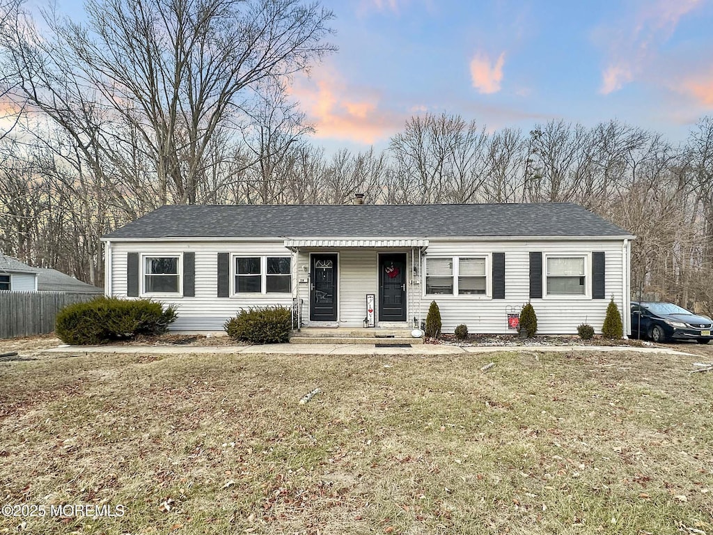 ranch-style house featuring a lawn