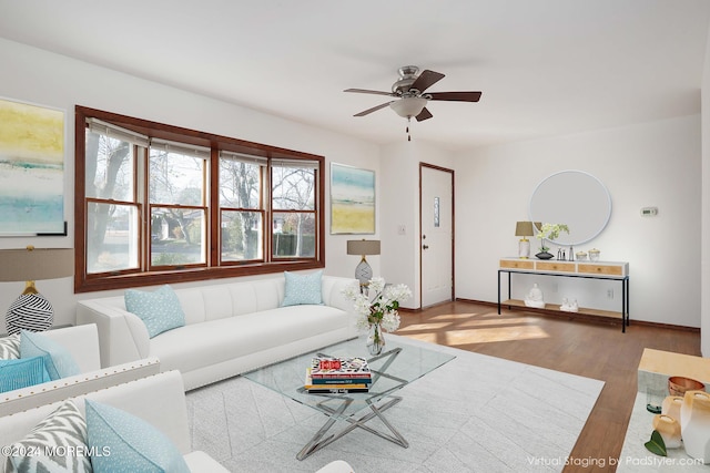 living room featuring hardwood / wood-style floors and ceiling fan