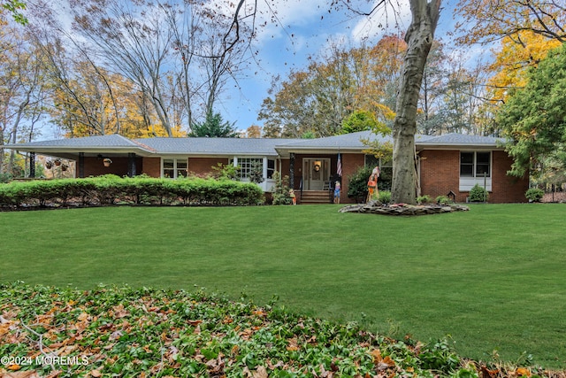 ranch-style home featuring a front yard