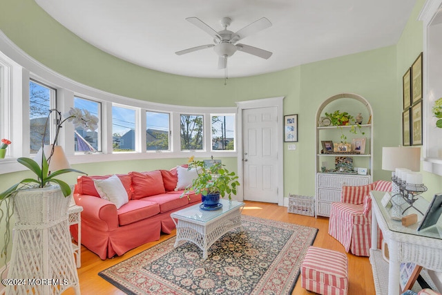 living room featuring a wealth of natural light, ceiling fan, and light hardwood / wood-style flooring