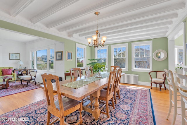 dining space with light wood-type flooring, radiator heating unit, and beamed ceiling