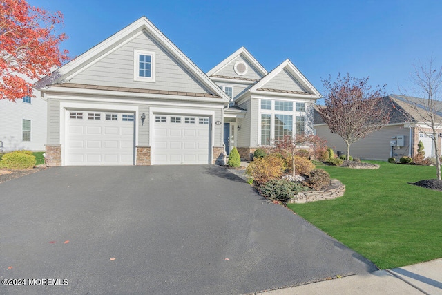 view of front of property with a garage and a front yard