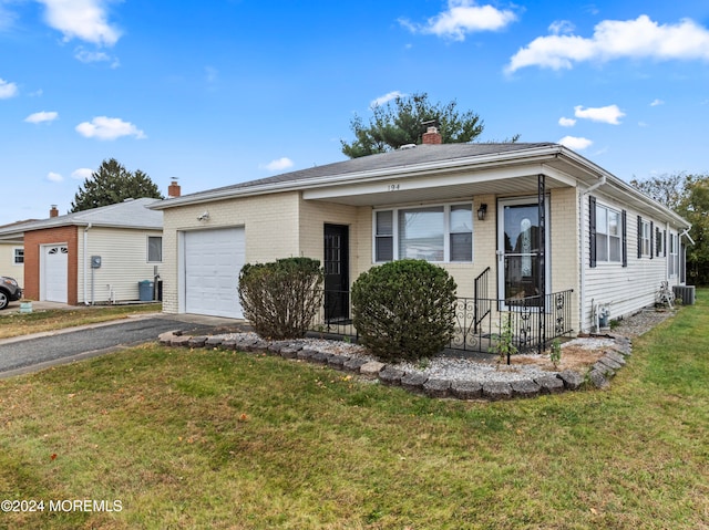 single story home featuring a garage and a front lawn