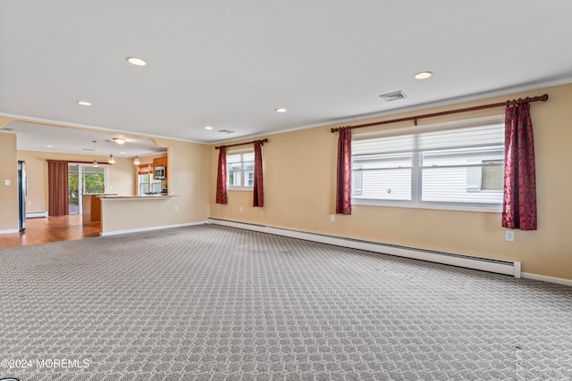 carpeted spare room featuring baseboard heating and crown molding