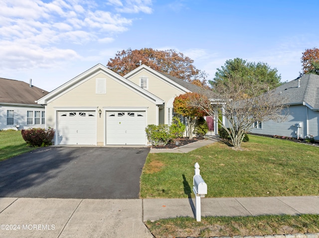 view of front facade with a garage and a front lawn