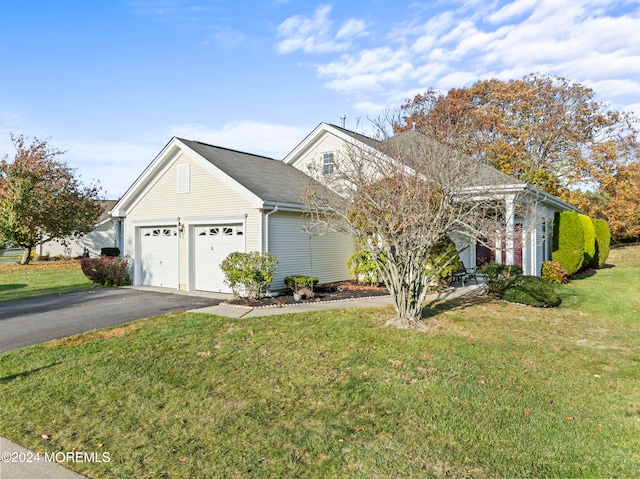 view of front of home with a garage and a front yard