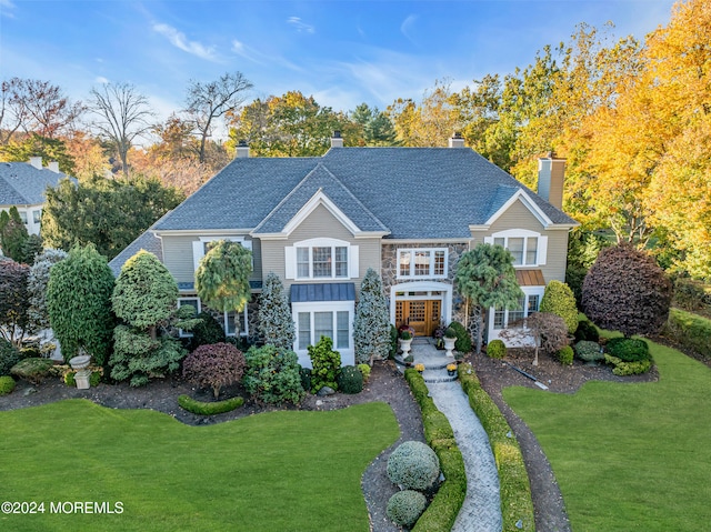 25 Bruns Rd, West Allenhurst, NJ 07711 - view of front facade with a chimney, a front lawn, and stone siding