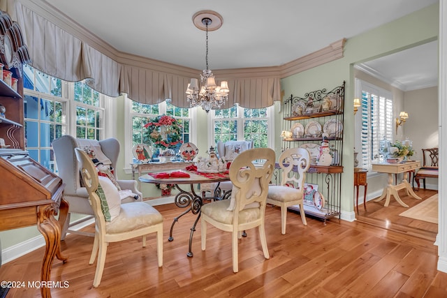 dining room featuring ornamental molding, a notable chandelier, and hardwood / wood-style flooring