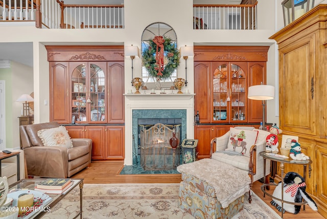 living room featuring a high ceiling and light hardwood / wood-style flooring