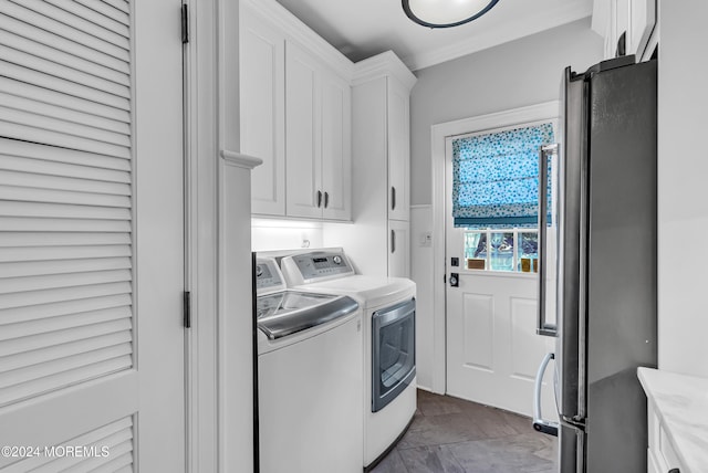 laundry room with washing machine and dryer and cabinets