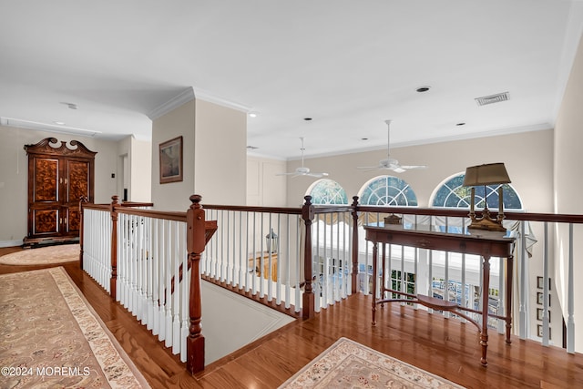 corridor featuring hardwood / wood-style flooring and crown molding