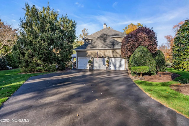 25 Bruns Rd, West Allenhurst, NJ 07711 - view of side of home featuring driveway, a shingled roof, and a chimney