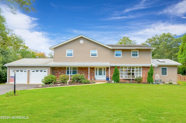 view of front of home with a garage and a front lawn