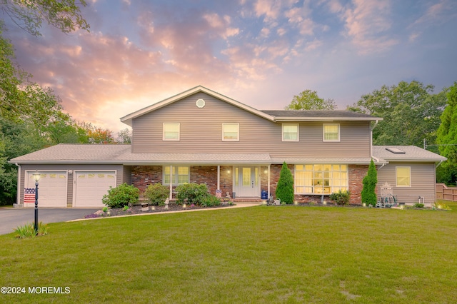 view of property featuring a lawn and a garage